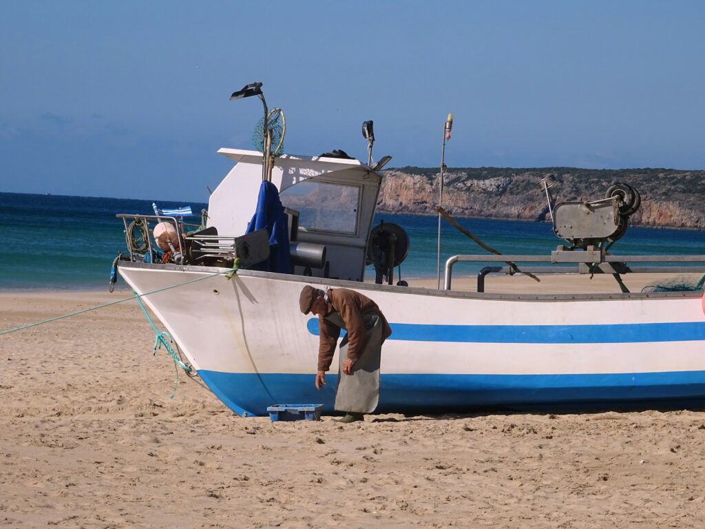 Fisherman on Salema beach, Salema, Portugal